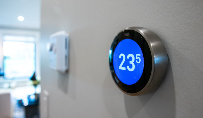 A smart thermostat installed on the wall