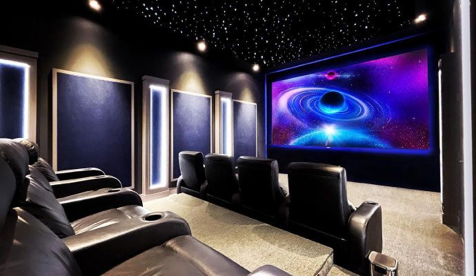 Luxury home theater with reclining seats and starry ceiling