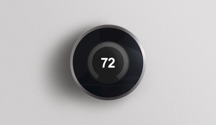 A smart thermostat mounted on a wall