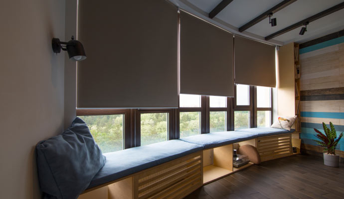 Automated window treatment installed in a furnished room