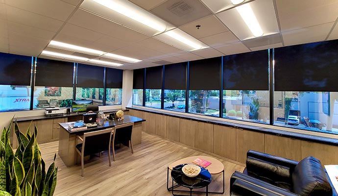 Automated window coverings installed to manage light Modern room with motorized window coverings for optimal light control