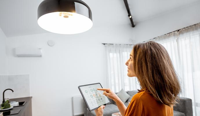 Woman controlling home lights with a tablet