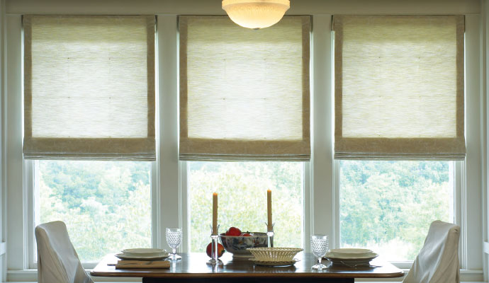 Partially raised Roman fold shade window cover